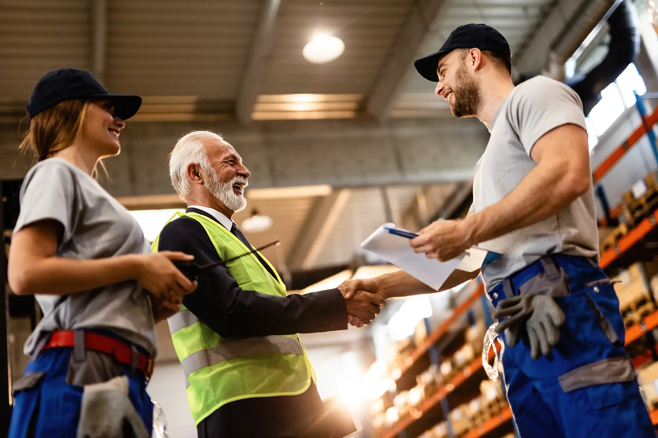 Two men in a warehouse shaking hands